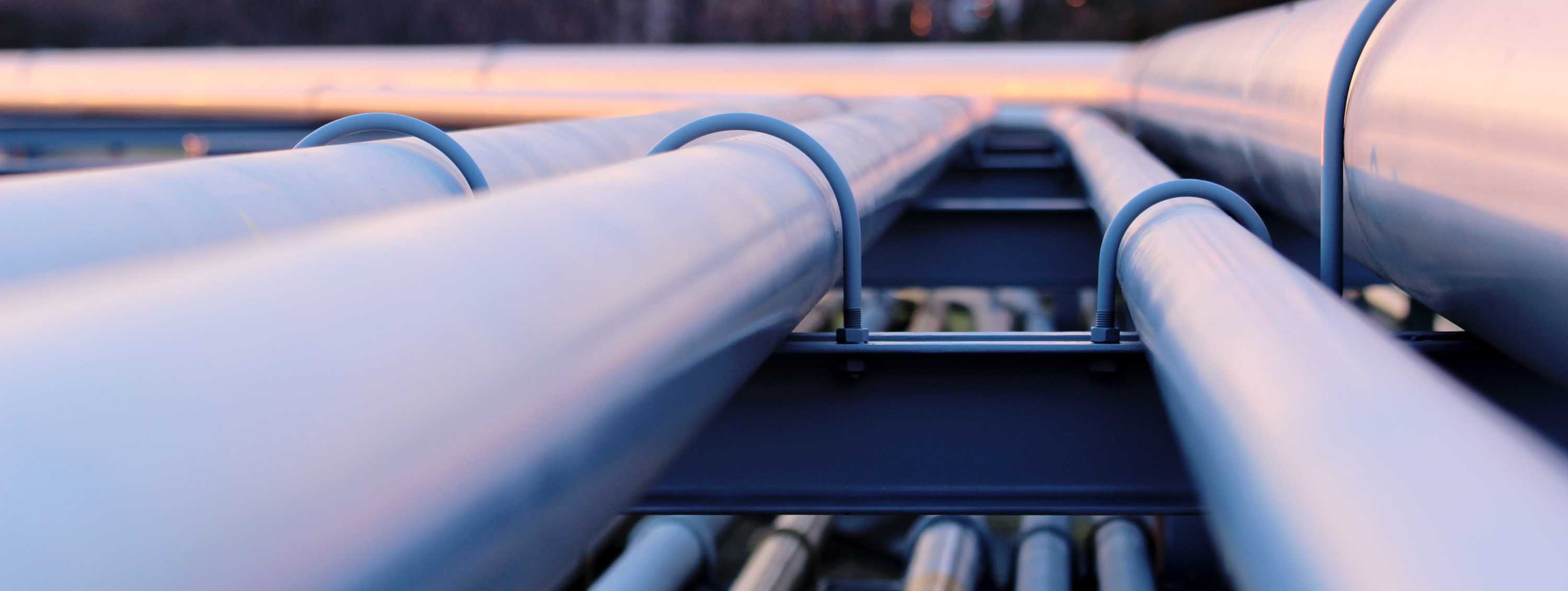 I picture of some pipes running to a industrial plant