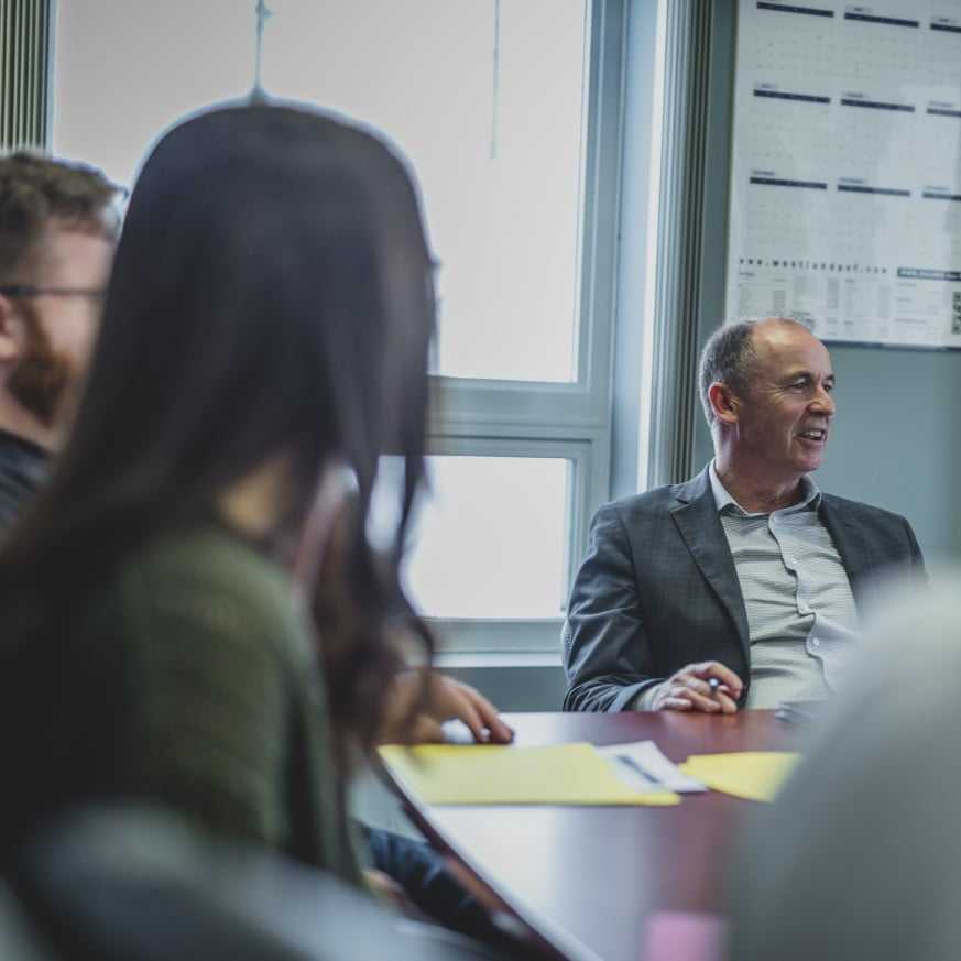 People in a board room having a discussion.
